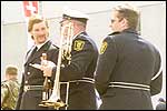 Trombone player juggles with beer, bratwurst and trombone